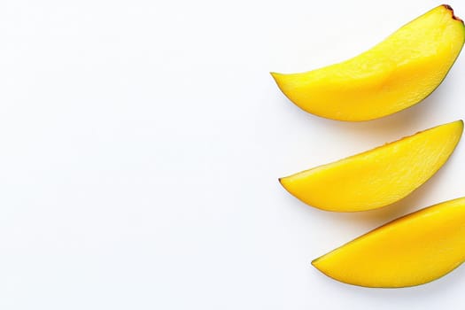 Dried mango slices are displayed in a clean arrangement on a solid white background, showcasing their vibrant yellow color and natural shape, perfect for snacking or culinary use.