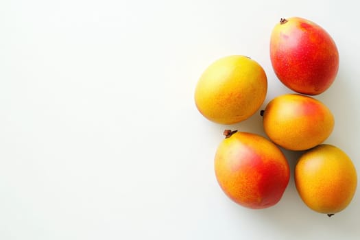 A group of exotic mangoes showcases a mix of yellow and red hues against a clean white background, emphasizing their juicy appeal and freshness perfect for culinary use.