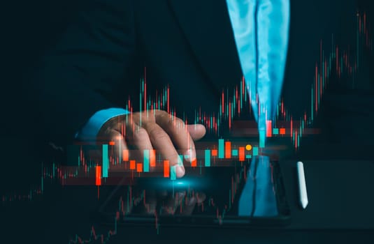 Businessman use laptops to analyze stock market, investment strategies. and business growth analysis, investing in companies with long-term competitive advantages, Broker use tablet analysing trading.