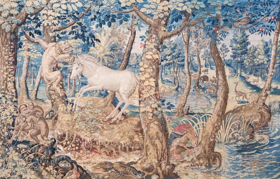 Isola Bella, Italy - 1 August 2023: detail of antique Italian tapestry in Borromeo Palace. Ancient decoration on indoor walls, fantasy creature