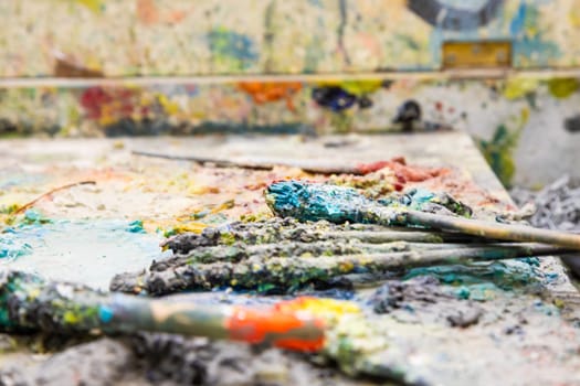 View of artistic equipments painting tools on artist table