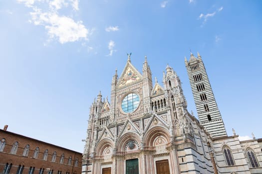 Siena cathedral in Italy. White marbles with blue sky, famous landmark of Tuscany