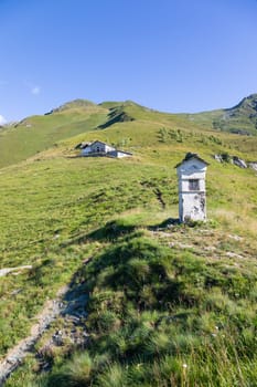 Panorama of Italian Alps with blue sky and clouds. Calm landscape, tranquil scenic view.