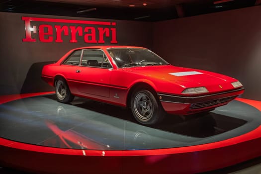 Turin, Italy - 11 november 2023: Car Museum. Red Ferrari 365 GT4, 1973. Italian design, luxury vintage car