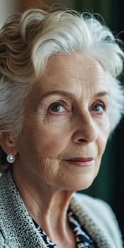 Sophisticated older French woman sits contemplatively in a softly lit room. Demeanor reveals a lifetime of experiences and reflections, embodying grace and wisdom. Well-groomed woman 70 years old. AI.