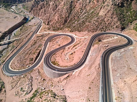 Bendy mountain road across the the Andes mountains near Potrerillos, Argentina. Aerial view.