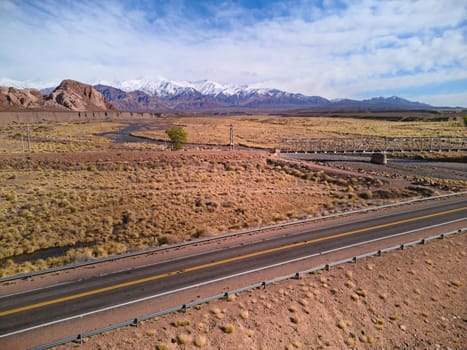 Asphalt road by the Andes mountains near Uspallata, Argentina.