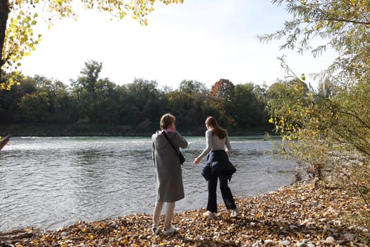 Two women enjoy the autumn atmosphere at the Isteiner Schwellen on the Rhine near Efringen-Kirchen (Lörrach district). In bright sunshine,numerous excursionists from Germany and abroad took advantage of the beautiful late summer weather on Sunday to take a trip to the Rhine.
