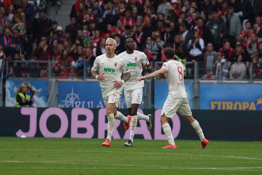 Goalkeeper Florian Müller (SC Freiburg) scores to make it 3-1,Chrislain Matsima (FC Augsburg) and Elvis Rexhbeçaj (FC Augsburg) congratulate in the match of the 1st FBL: 24-25: 1st FBL: 24-25: 7th Sptg. SC Freiburg - FC Augsburg  DFL REGULATIONS PROHIBIT ANY USE OF PHOTOGRAPHS AS IMAGE SEQUENCES AND/OR QUASI-VIDEONann  Photo: Joachim Hahne/johapress
