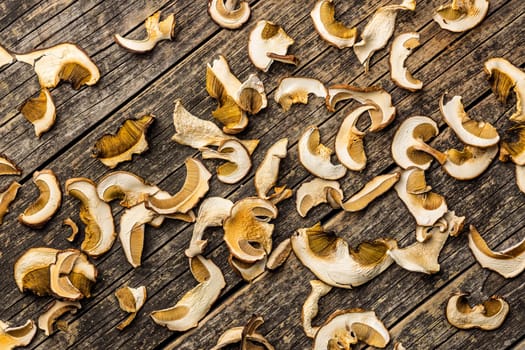 Dried porcini mushrooms. Sliced boletus on a wooden table. Top view.