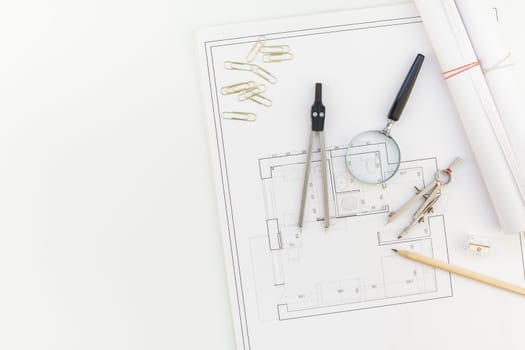 Creative flat lay overhead top view blueprints architectural flat project plan and office supplies on decorator white table workspace with swatches tools and equipment background copy space concept