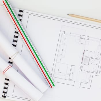 Creative flat lay overhead top view blueprints architectural flat project plan and office supplies on decorator square white table workspace swatches tools and equipment background copy space concept
