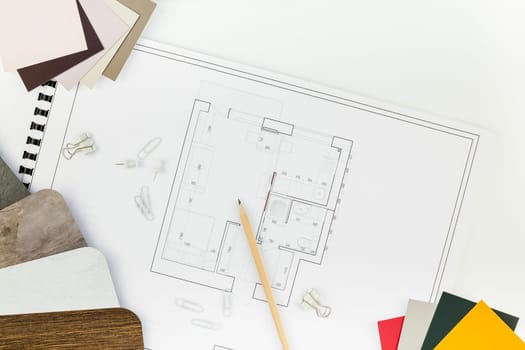 Creative flat lay overhead top view blueprints architectural flat project plan and office supplies on decorator white table workspace with swatches tools and equipment background copy space concept