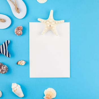 Creative flat lay concept of summer travel vacations. Top view of seashells and starfish on turquoise blue background with postcard mock up and copy space in minimal style, template for text