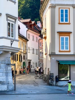 Ljubljana, Slovenia - August 15, 2023: People walking outdoors in the street, Old Town. High quality photo