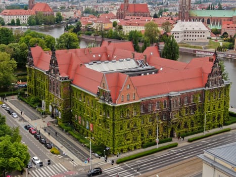 Aerial view of the National Museum building covered with green ivy, Ostrow Tumski in the background. High quality photo