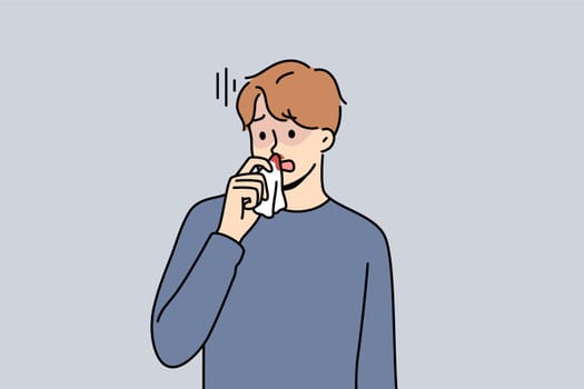 Blood from nose in sick man suffering from intracranial pressure or dangerous virus that reduces stability of vessels. Blood from nose causes stress and discomfort in guy holding nasal tissue
