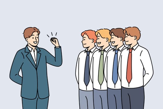Business man leader gives motivational speech to team of office clerks standing in row. Manager with leadership qualities conducts motivational training for colleagues to increase productivity