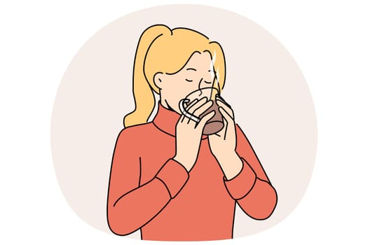 Woman drinks hot tea to keep warm and quench thirst after walk in park in cold winter weather. Girl in sweater holds mug of tea and enjoys taste and aroma of drink made from natural herbs