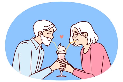 Elderly romantic couple drinking cocktail from straws together enjoying retirement and dating