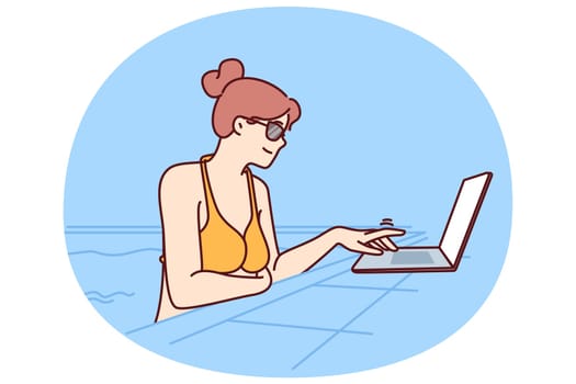Woman freelancer is swimming in pool and using laptop while doing work over internet. Girl in bikini is using computer while working as freelancer and relaxing on vacation at same time.