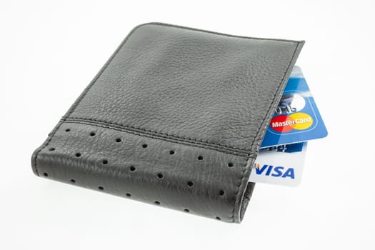 CROATIA, ZAGREB - 13 JUNE 2010: visa and mastercard credit cards in a black leather wallet isolated on a white background. Illustrative editorial image
