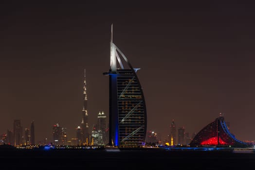 UAE, DUBAI - DECEMBER 26: Night cityscape of Dubai city with Burj Al Arab Jumeirah building on the front, United Arab Emirates on December 26, 2014