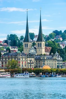 SWITZERLAND, LUZERN - AUGUST 23: view of historic Luzern city center with river Reuss and church of Saint Leodegar on August 23, 2015