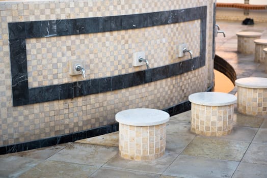 Ablution taps where worshippers wash their feet before prayer time in Sheikh Zayed White Mosque in Abu Dhabi, UAE