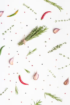 Flat lay overhead top view of greens herbs and spices on white background with copy space. Menu frame design food pattern background with cooking ingredients