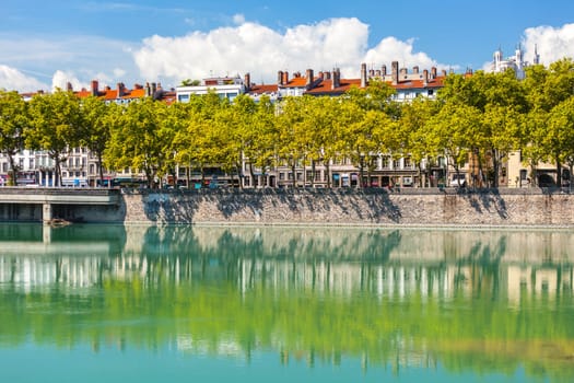 Cityscape of Lyon, France with reflections in the water. Bright sunny day
