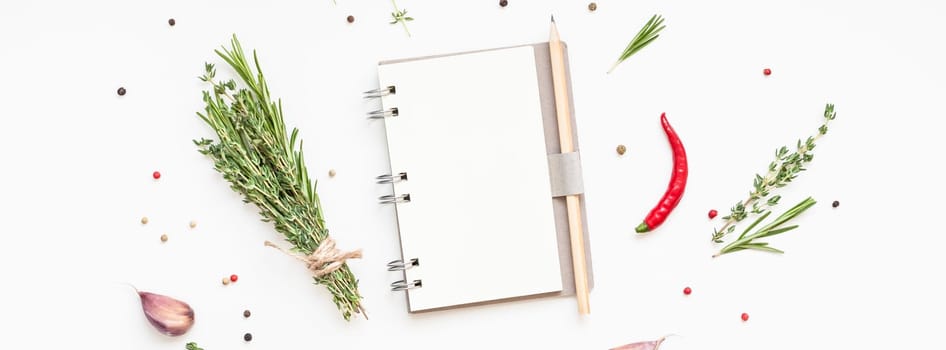 Flat lay overhead view blank notebook pages mockup text space invitation card on white background with greens herbs and spices. Menu or recipe book or food blog design with cooking ingredients