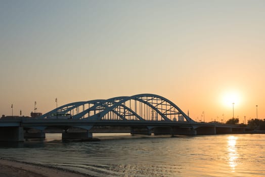 Maqta Bridge in Abu Dhabi, United Arab Emirates. Sunset view with water reflections