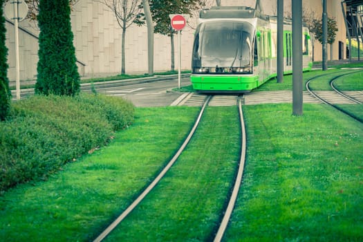 Tram rails covered with green grass lawn in Bilbao, Spain