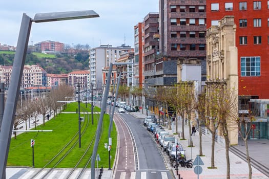 Street of Bilbao, Spain with old ruin and modern buildings