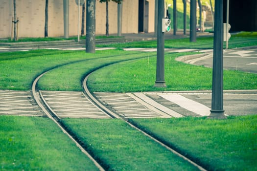 Tram rails covered with green grass lawn in Bilbao, Spain