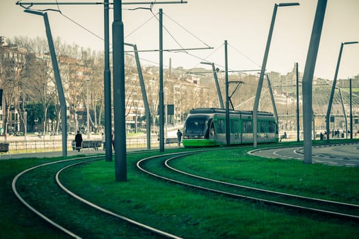Tram rails covered with green grass lawn in Bilbao, Spain