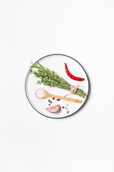 Flat lay overhead view empty plate mockup blank text space invitation card on white background with greens herbs and spices. Menu design food background with cooking ingredients