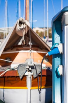 Moored yachts charching with fuel and electricity in Marina of Cannes, France