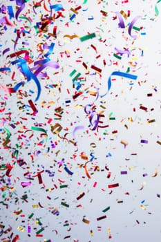 coloured confetti as a white New Year's background. AI generative.