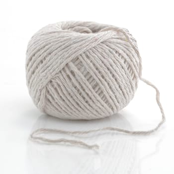 A grey ball of string on white background