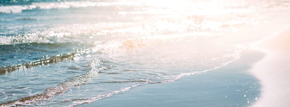 Summer sand beach and seashore waves background. Defocused holiday vacations concept backdrop for motivational quotes, blog posts, your text. Long wide banner