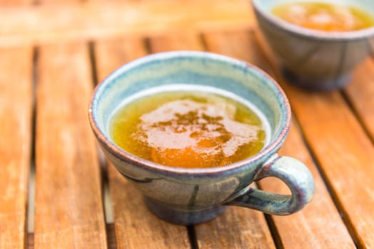 Norman apple cider in a typical ceramic cups. Shot with a selective focus