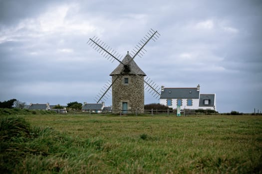 Dull Landscape with Old windmill in Brittany, Western France. Toned image