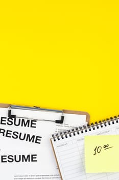 Creative top view flat lay of desk with resume documents copy space on bold yellow background in minimal style. Concept of new job, hiring recruitment process, new team members screening