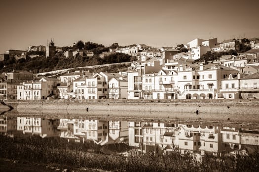 View of city Alcacer do Sal near the river Sado in Portugal. Horizontal sepia filtered shot