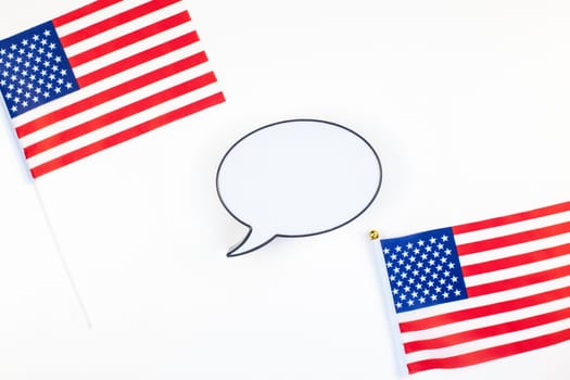 Creative top view flat lay of American flags for Elections, Memorial Day, 4th of July or Labour Day with bubble lightbox mockup with copy space white background. Concept of patriotism and independence
