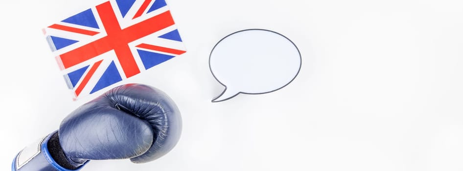 Creative top view flat lay of boxing glove with Great Britain flag with empty bubble lightbox mockup and copy space on white background minimal style. Concept of politic fights in Europe