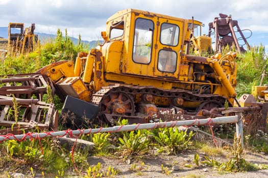 Old rusty and weathered bulldozers. Outdoors horizontal shot
