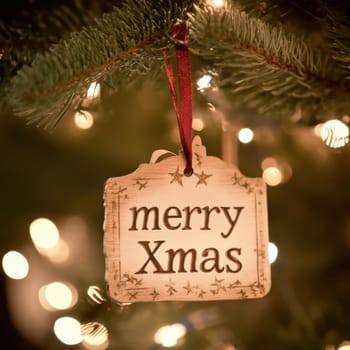 A wooden ornament with the inscription Merry Xmas is beautifully displayed on a Christmas tree adorned with twinkling lights.